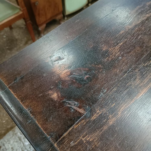 49 - A carved oak writing desk, with a hinged fall front, 84 cm wide<br /><br />Please note collection is...