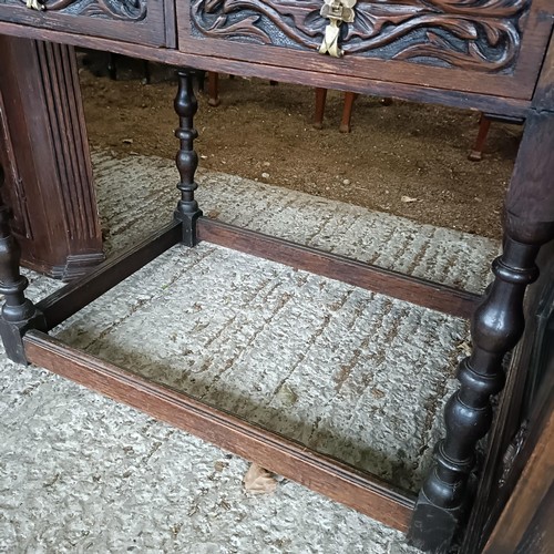 49 - A carved oak writing desk, with a hinged fall front, 84 cm wide<br /><br />Please note collection is...