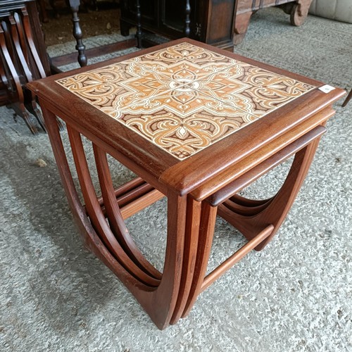 50 - A 20th century nest of teak tile top coffee tables, 15 cm wide (3)<br /><br />Please note collection...