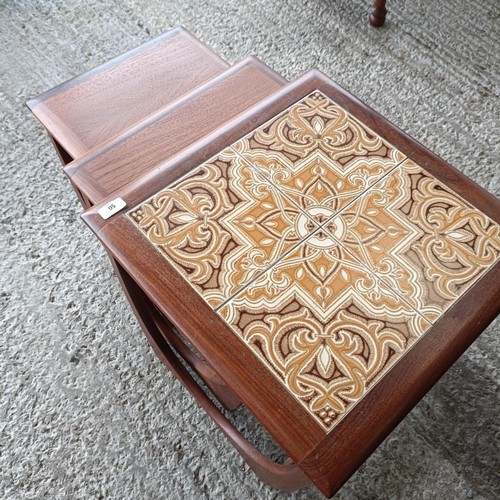 50 - A 20th century nest of teak tile top coffee tables, 15 cm wide (3)<br /><br />Please note collection...