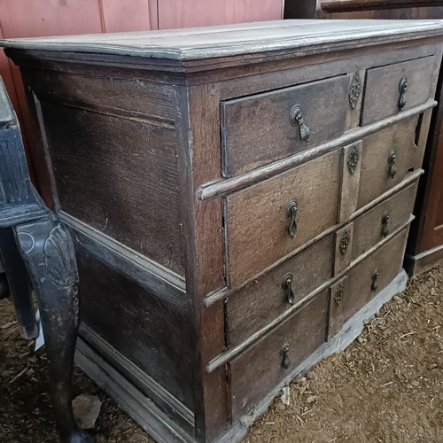 22 - An 18th century oak chest, with two short and three long drawers, 104 cm wide<br /><br />Please note...