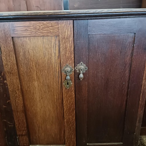 23 - An oak cupboard, having four cupboard doors, 153 cm wide<br /><br />Please note collection is from T...