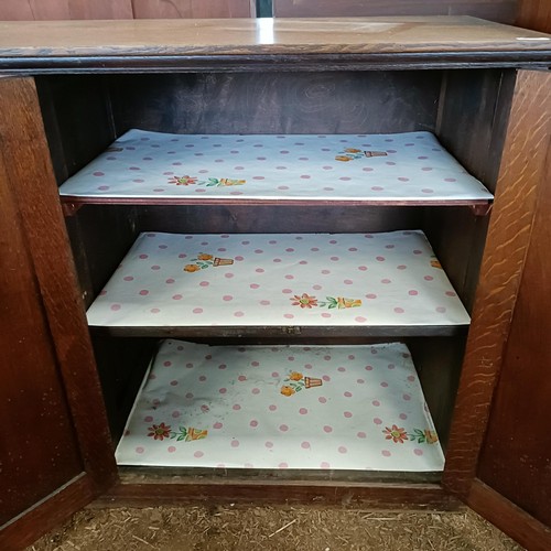 23 - An oak cupboard, having four cupboard doors, 153 cm wide<br /><br />Please note collection is from T...