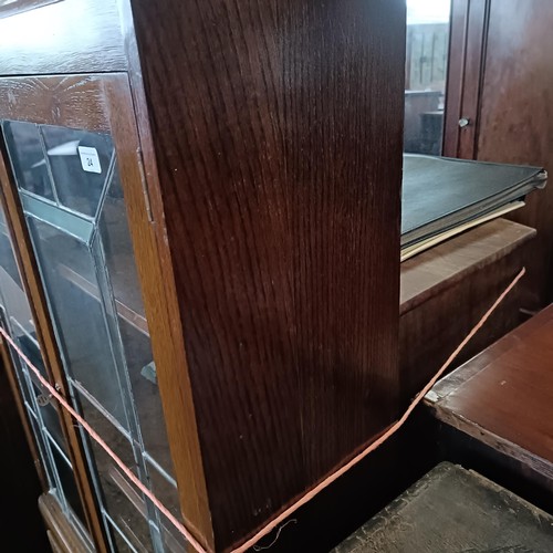 24 - An Art Deco oak display cabinet, 85 cm wide<br /><br />Please note collection is from TA9 4LJ only o...