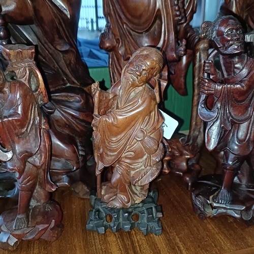 31 - A Chinese carved wooden figure, 38 cm high, its pair, and four others (6)Please note collection is f... 