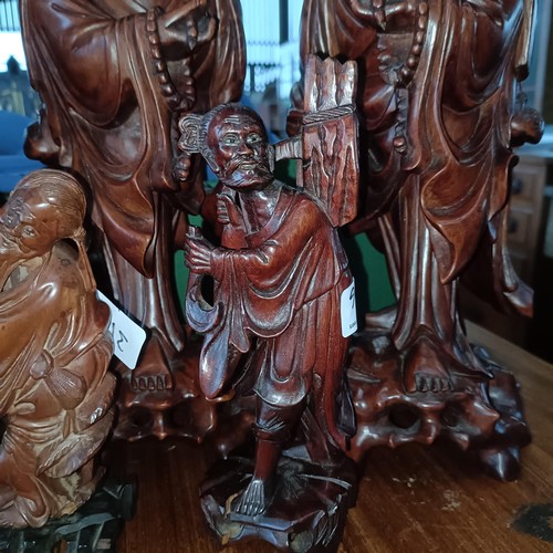 31 - A Chinese carved wooden figure, 38 cm high, its pair, and four others (6)Please note collection is f... 