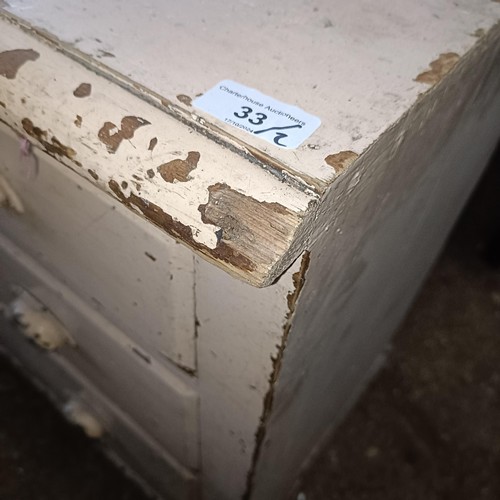 33 - A painted pine chest, with three long drawers, 86 cm wide, and an armchair<br /><br />Please note co...