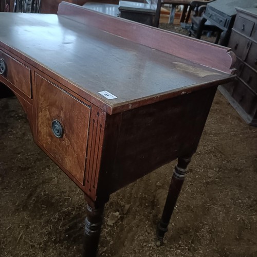 35 - A mahogany kneehole dressing table, with three drawers, 105 cm wide<br /><br />Please note collectio...