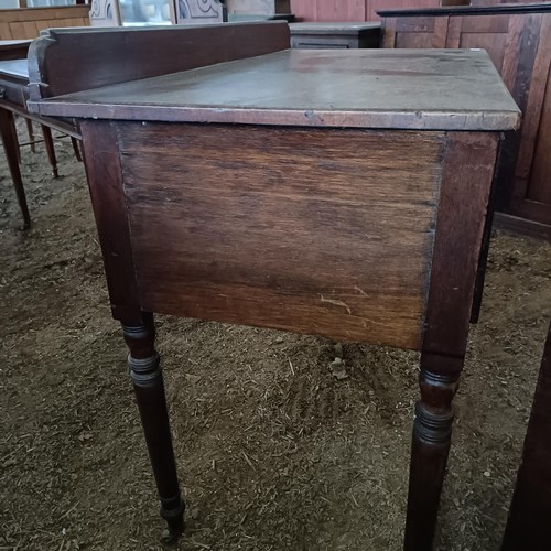 35 - A mahogany kneehole dressing table, with three drawers, 105 cm wide<br /><br />Please note collectio...