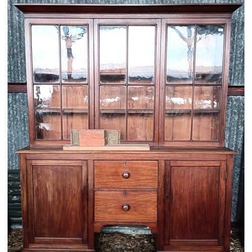 69 - A 19th century mahogany bookcase cabinet, the top with three glazed doors, the base with two drawer ... 