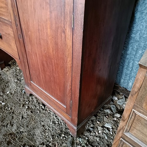 69 - A 19th century mahogany bookcase cabinet, the top with three glazed doors, the base with two drawer ... 