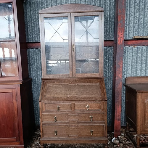 70 - An oak bureau bookcase, 82 cm wide, and a sideboardPlease note collection is from TA9 4LJ only on 22... 