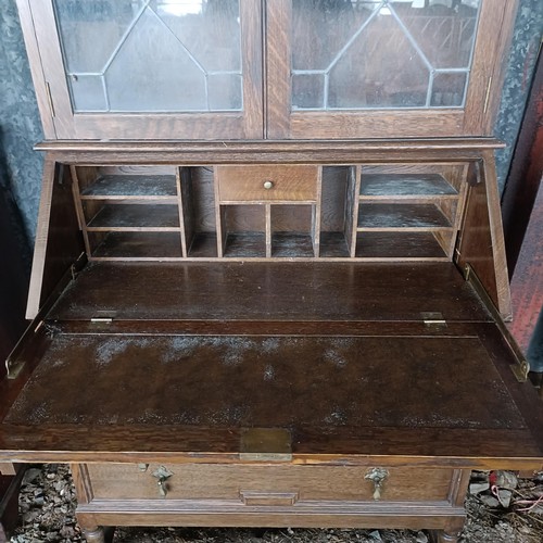 70 - An oak bureau bookcase, 82 cm wide, and a sideboardPlease note collection is from TA9 4LJ only on 22... 