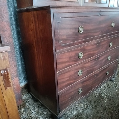 77 - A George III mahogany secretaire bookcase, the top with two glazed doors, above a fitted drawer, and... 