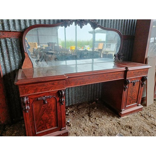 81 - A 19th century mahogany sideboard with a mirrored back, to a base with three drawers, and two cupboa... 