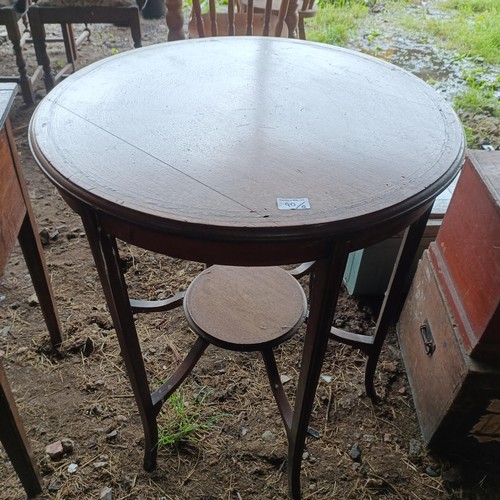 90 - A mahogany lamp table, 68 cm diameter, a painted trunk, 48 cm wide, two other trunks and three suitc... 