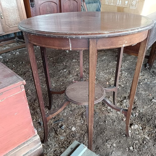 90 - A mahogany lamp table, 68 cm diameter, a painted trunk, 48 cm wide, two other trunks and three suitc... 