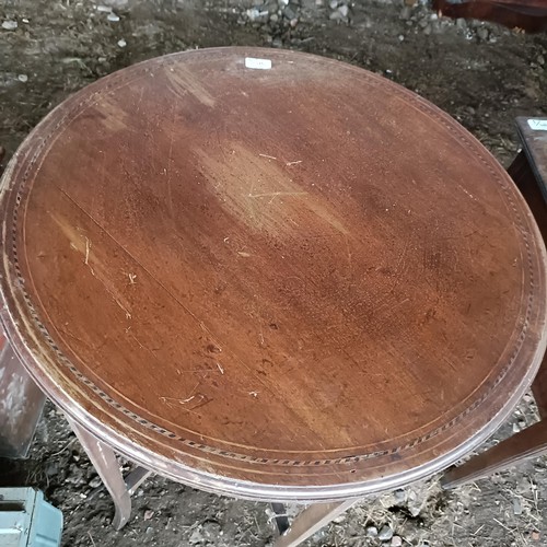 90 - A mahogany lamp table, 68 cm diameter, a painted trunk, 48 cm wide, two other trunks and three suitc... 