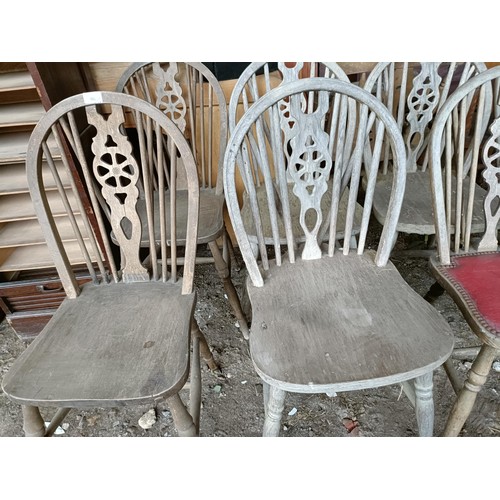 96 - A set of seven wheel back kitchen chairs, and a similar set of five (11)Please note collection is fr... 