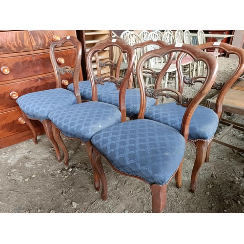 98 - A set of six Victorian walnut dining chairs, with carved central rails, padded seats and cabriole le... 