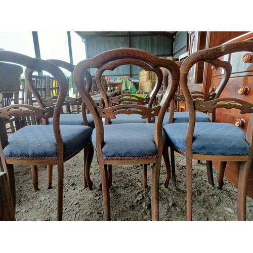 98 - A set of six Victorian walnut dining chairs, with carved central rails, padded seats and cabriole le... 