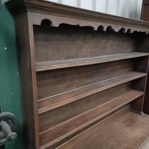 111 - An oak dresser, with three tier plate rack on a base with two drawers, 146 cm widePlease note collec... 