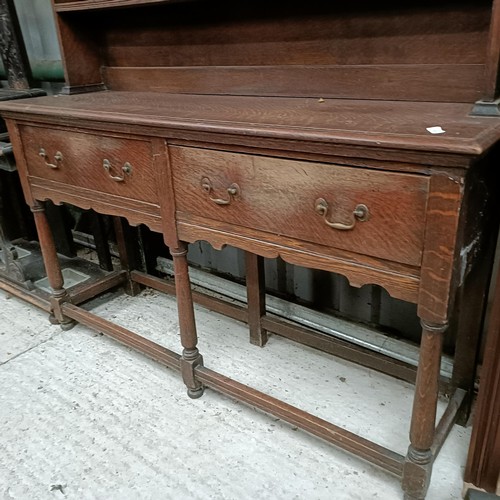 111 - An oak dresser, with three tier plate rack on a base with two drawers, 146 cm widePlease note collec... 