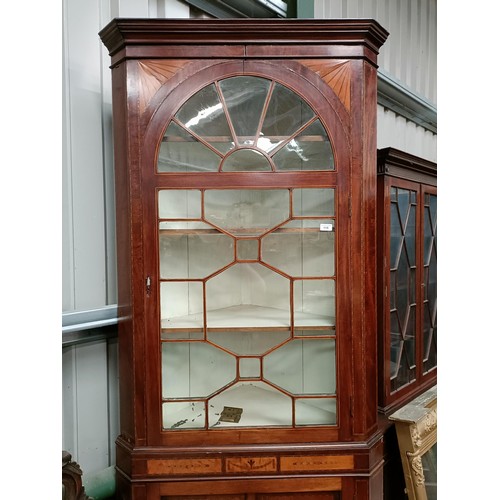 115 - A 19th century mahogany inlaid Sheraton Revival corner cupboard, with a domed top glazed door on a b... 