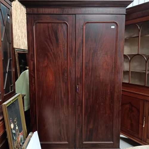 118 - A mahogany wardrobe, with two panel doors, 138 cm widePlease note collection is from TA9 4LJ only on... 