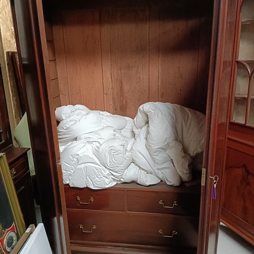 118 - A mahogany wardrobe, with two panel doors, 138 cm widePlease note collection is from TA9 4LJ only on... 