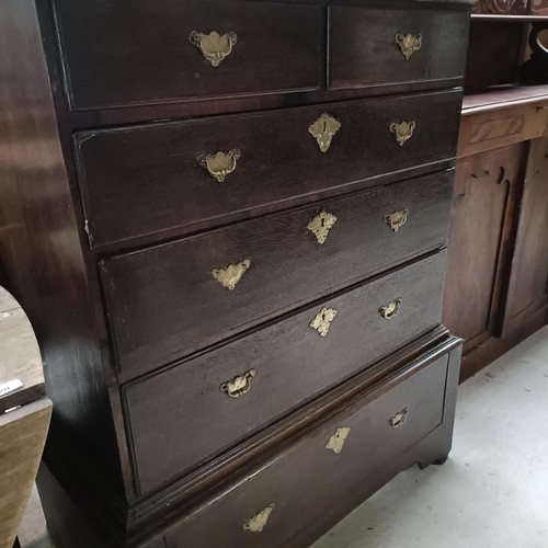 121 - An oak chest on stand, top with two short and three long drawers on a base with a single drawer, 95 ... 