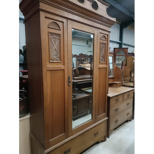 128 - An early 20th century walnut wardrobe, with a mirrored door, 125 cm wide, and a similar dressing tab... 