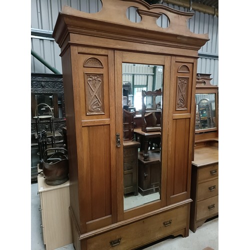 128 - An early 20th century walnut wardrobe, with a mirrored door, 125 cm wide, and a similar dressing tab... 