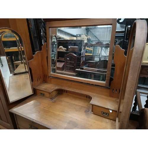 128 - An early 20th century walnut wardrobe, with a mirrored door, 125 cm wide, and a similar dressing tab... 