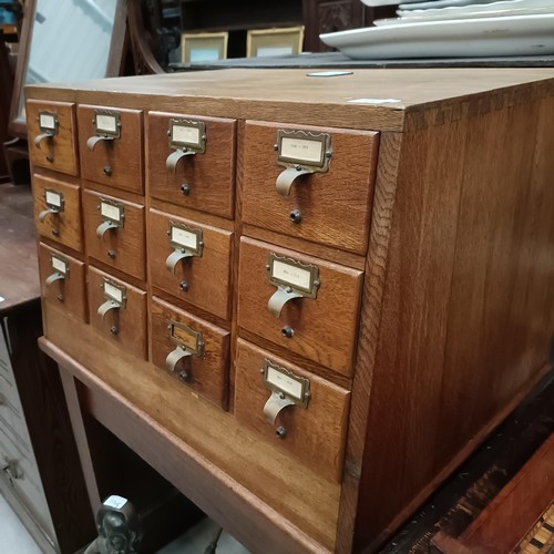 132 - An early 20th century filing chest, with twelve drawers, on a base, 68 cm widePlease note collection... 