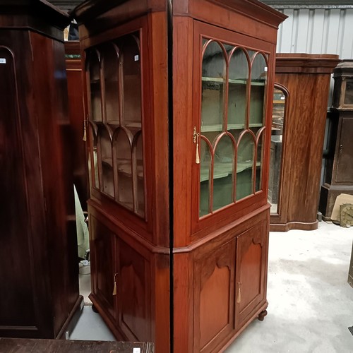 137 - A pair of mahogany corner cabinets, with glazed doors above two cupboard doors, 210 x 110 cmPlease n... 