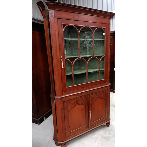 137 - A pair of mahogany corner cabinets, with glazed doors above two cupboard doors, 210 x 110 cmPlease n... 