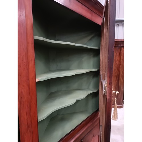 137 - A pair of mahogany corner cabinets, with glazed doors above two cupboard doors, 210 x 110 cmPlease n... 