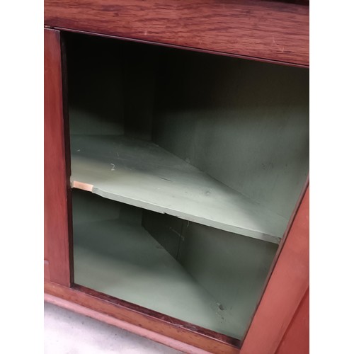 137 - A pair of mahogany corner cabinets, with glazed doors above two cupboard doors, 210 x 110 cmPlease n... 