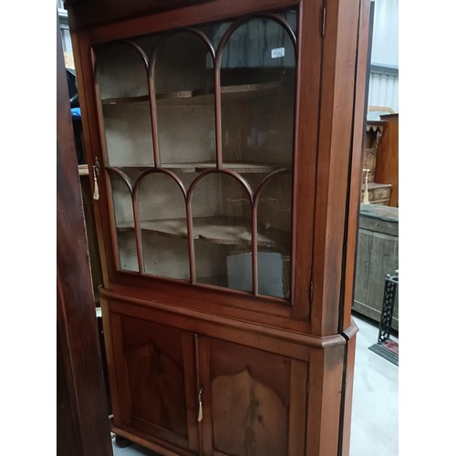 137 - A pair of mahogany corner cabinets, with glazed doors above two cupboard doors, 210 x 110 cmPlease n... 