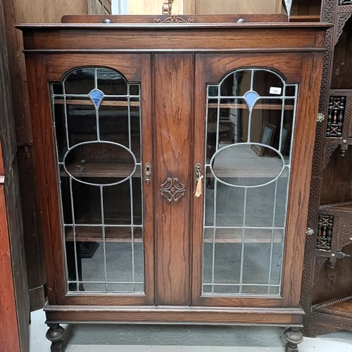 138 - An early 20th century oak bookcase, with leaded glazed doors, 107 cm widePlease note collection is f... 