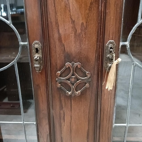 138 - An early 20th century oak bookcase, with leaded glazed doors, 107 cm widePlease note collection is f... 