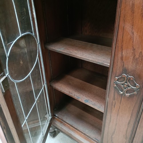 138 - An early 20th century oak bookcase, with leaded glazed doors, 107 cm widePlease note collection is f... 