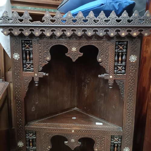 139 - An Anglo-Indian corner cabinet, with mother-of-pearl inlay, profusely carved with foliate forms, 176... 