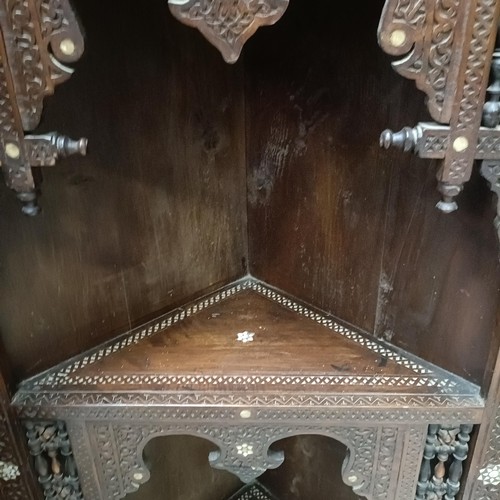 139 - An Anglo-Indian corner cabinet, with mother-of-pearl inlay, profusely carved with foliate forms, 176... 