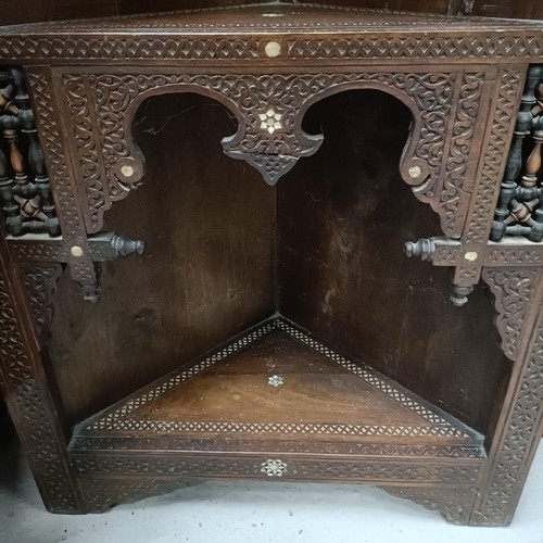 139 - An Anglo-Indian corner cabinet, with mother-of-pearl inlay, profusely carved with foliate forms, 176... 