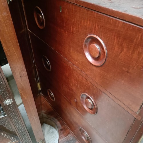 140 - A Victorian mahogany serpentine wardrobe, with a mirrored door, the interior with drawers and slides... 