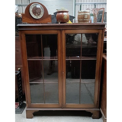 142 - A mahogany glazed bookcase, 97 cm wide, an Art Deco clock and two biscuit barrelsPlease note collect... 