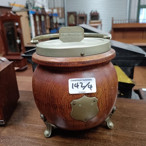 142 - A mahogany glazed bookcase, 97 cm wide, an Art Deco clock and two biscuit barrelsPlease note collect... 