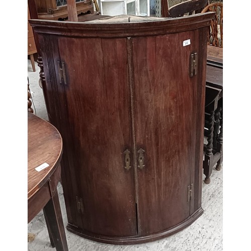 232 - A mahogany bow fronted corner cabinet, 76 cm widePlease note collection is from TA9 4LJ only on 22nd... 